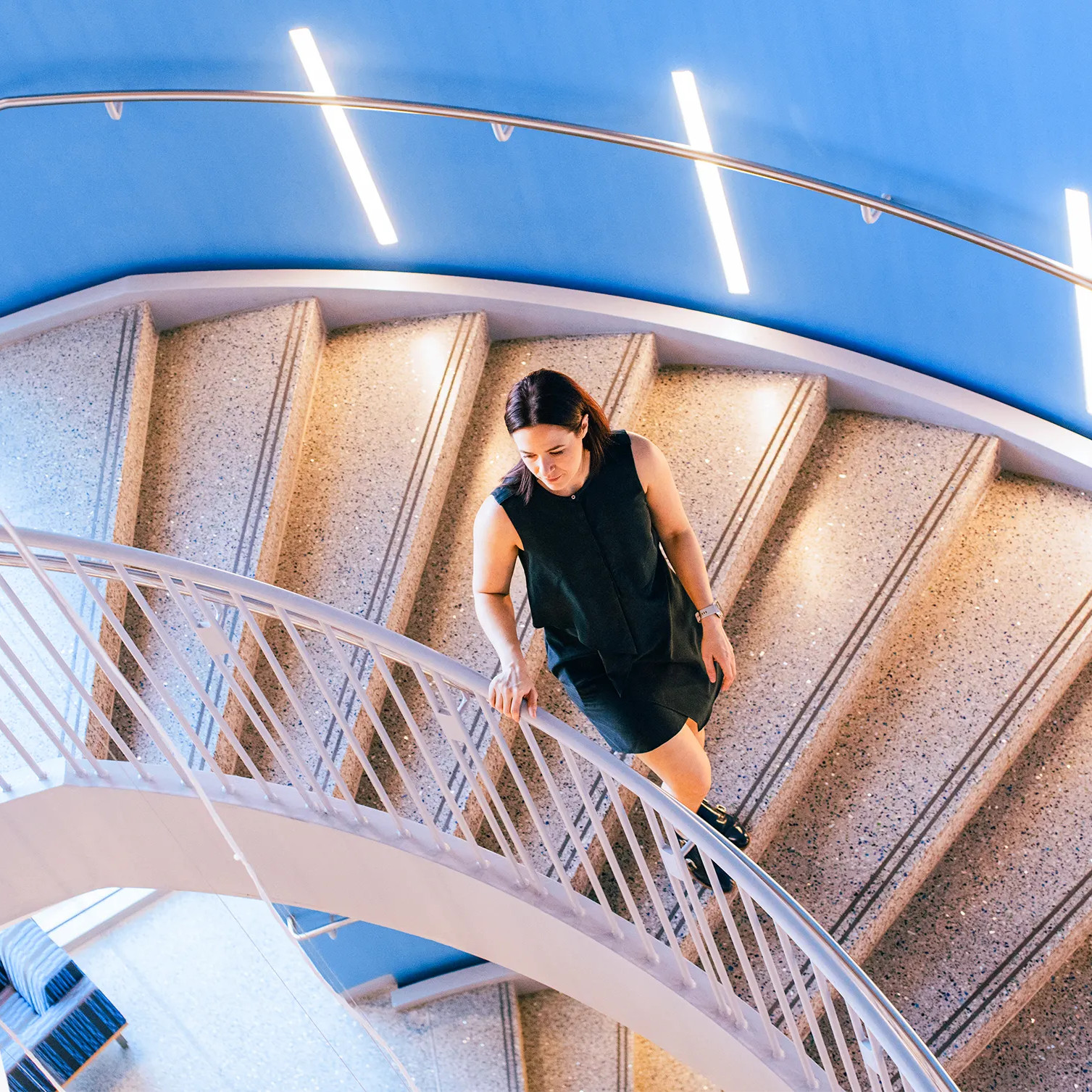 Shot of Erin Calipari in the Engineering and Science Building sprial staircase taken from above.