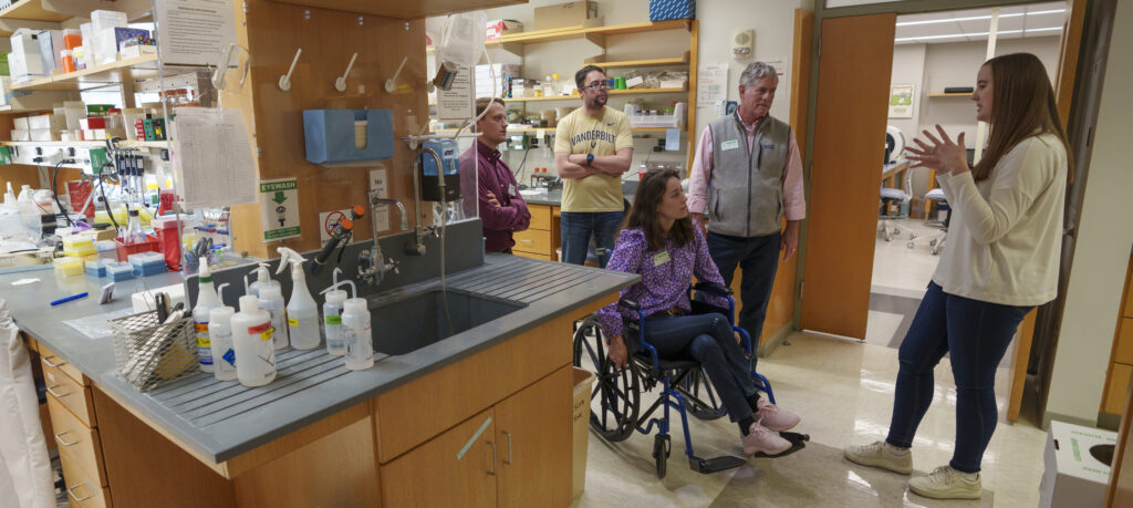 Five people talking in a scientific lab.