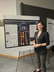 Claire Scott standing in front of her poster at the fifth Annual Vanderbilt Alzheimer’s Disease Research Day.