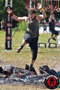 Photo of Karen Davis leaping over hot coals.