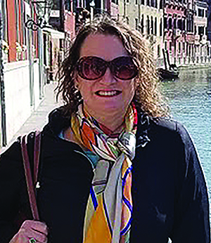 Photo of Beth Rivas standing next to a canal in Venice.