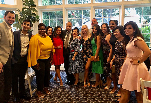 Photo of Fant (middle) and his wife, Ana María (right of him), at his retirement party in 2019 with some current and former fellows.