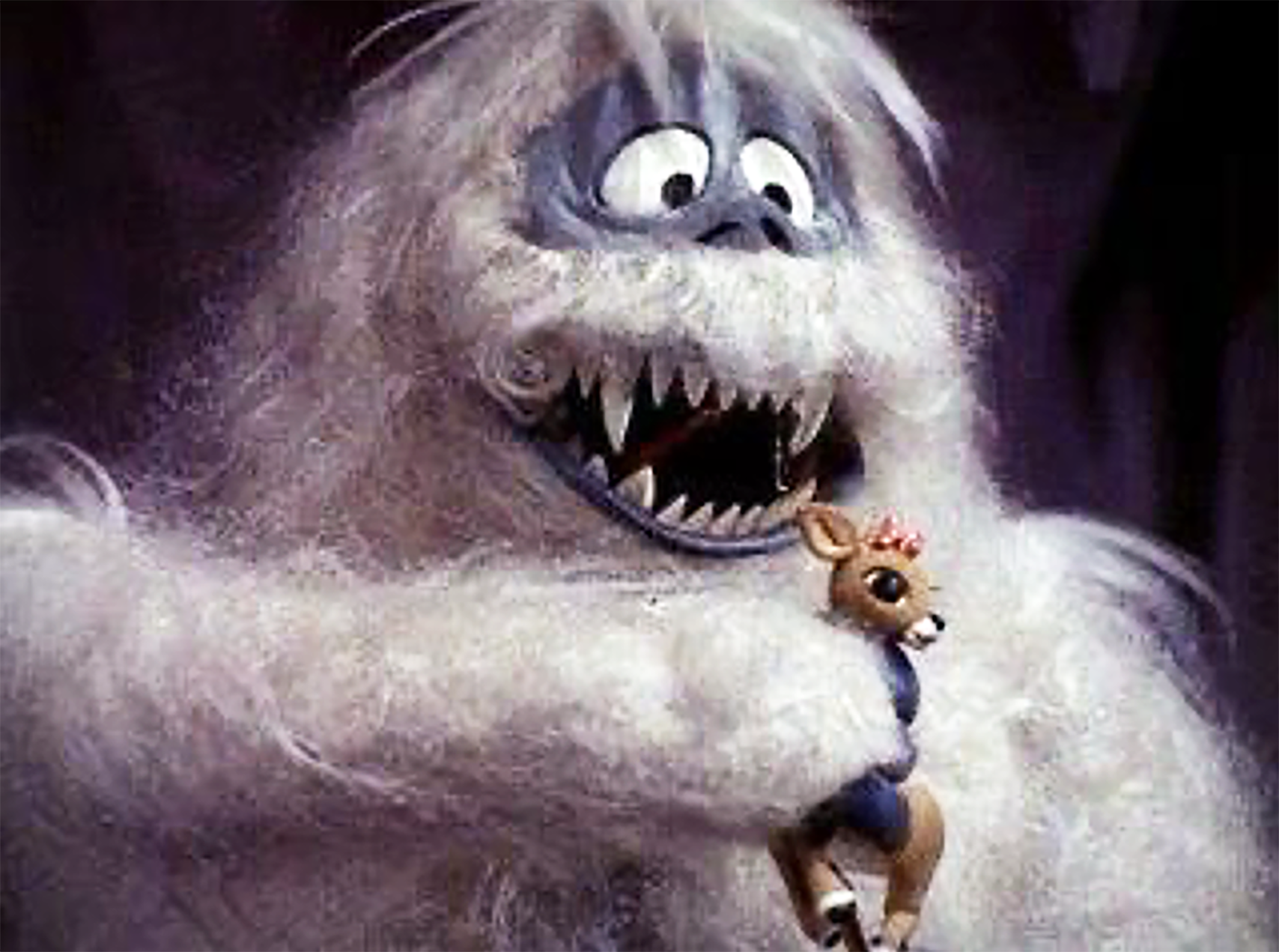 The Abominable Snow Monster holding Rudolph in its hands.