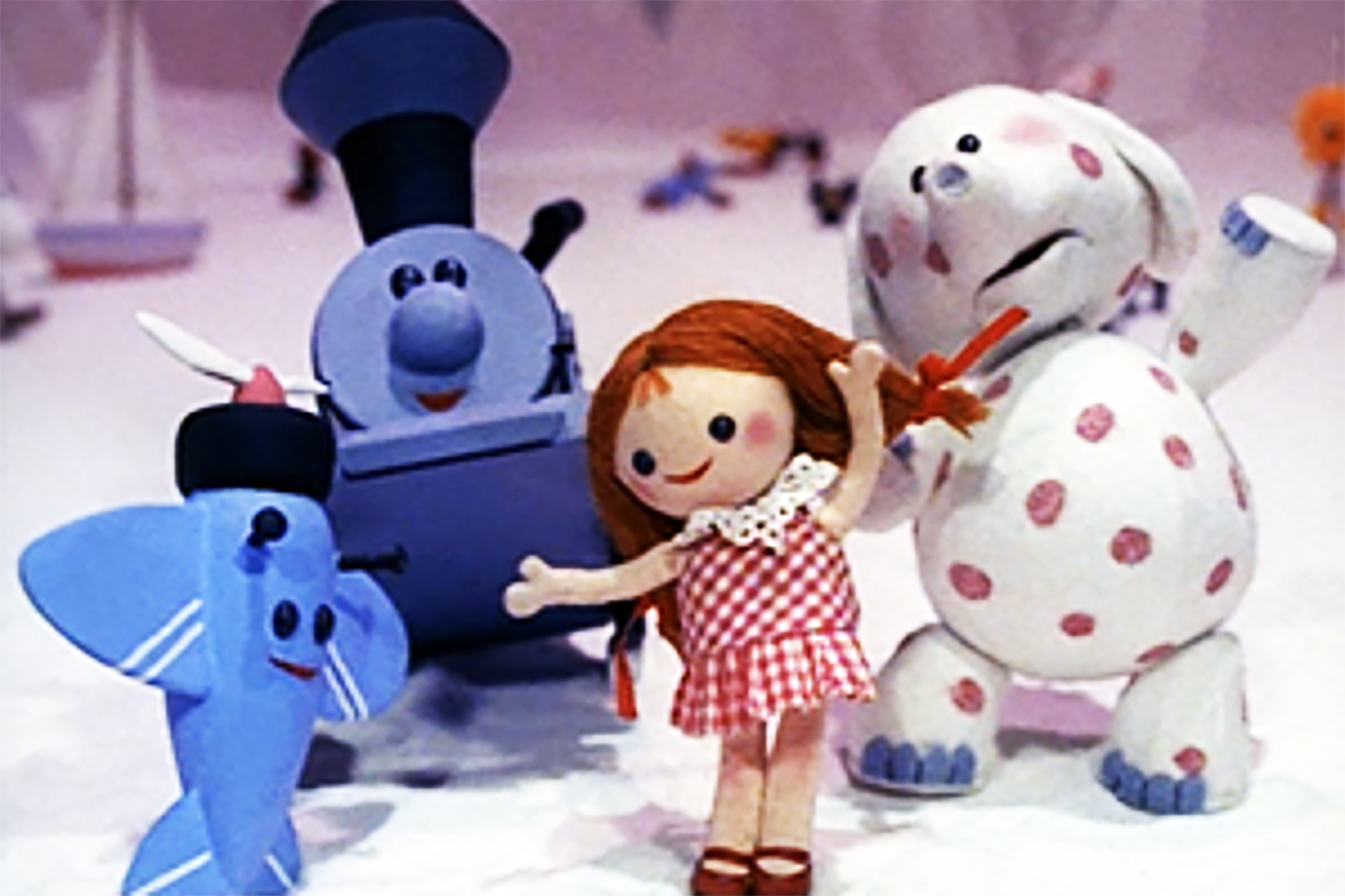 An assortment of misfit toys from the movie "Rudolph the Red-Nosed Reindeer." There is an airplane, a train, a doll, and a plush dog.