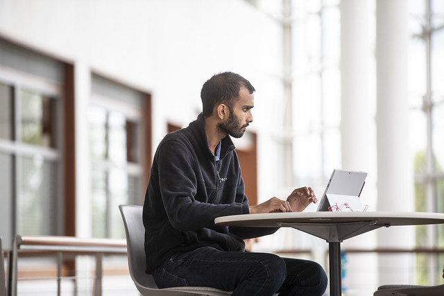 student at desk with laptop