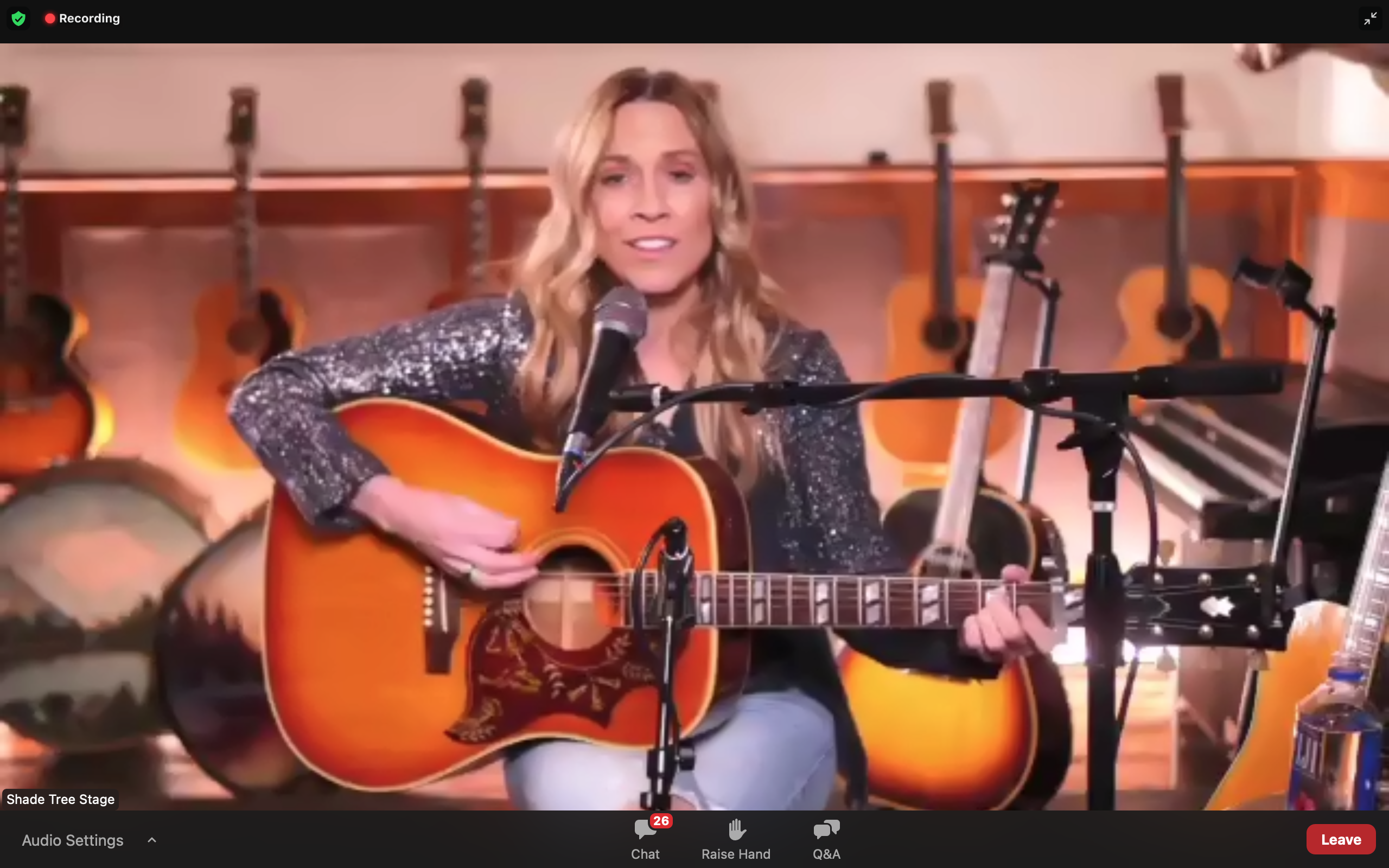 Grammy winner Sheryl Crow holds her guitar while playing on Zoom
