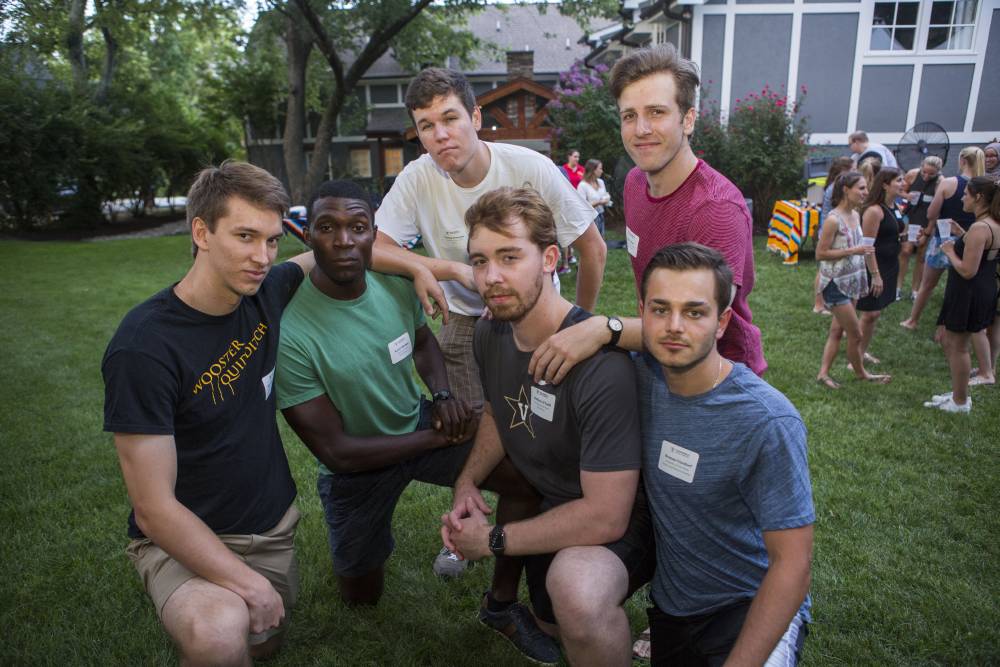 A group of men pose outside