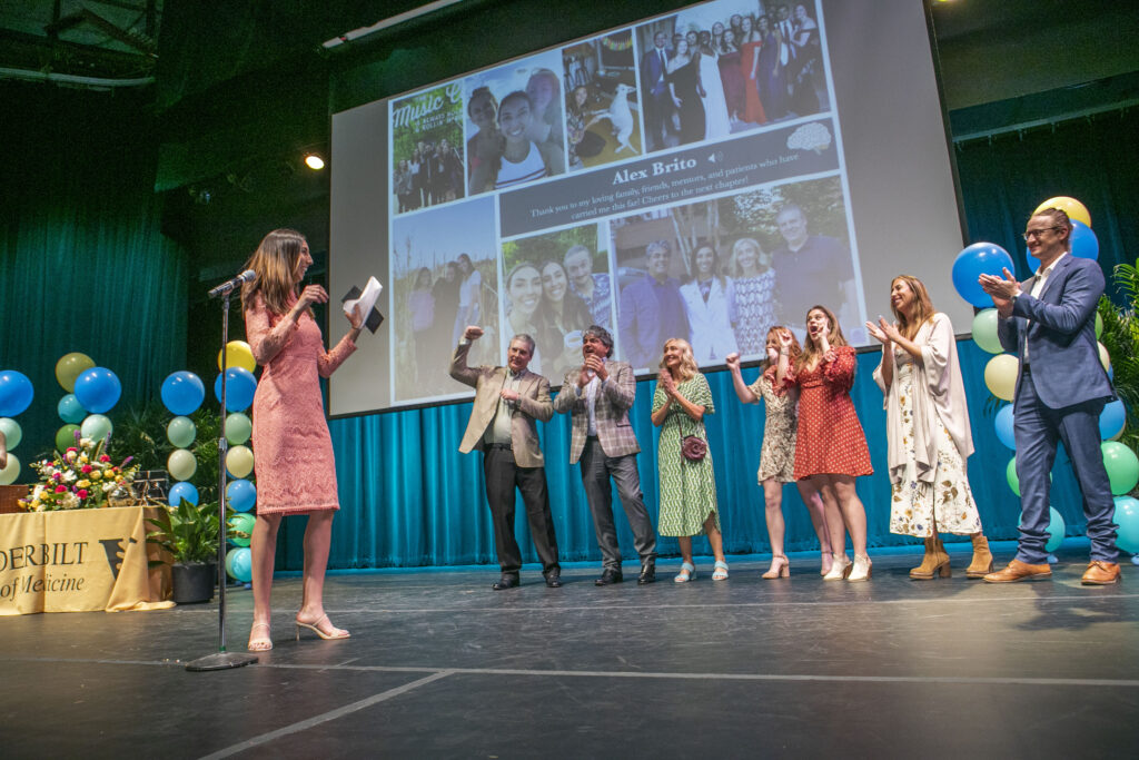 People on a stage cheer