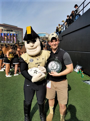 A person stands with a mascot