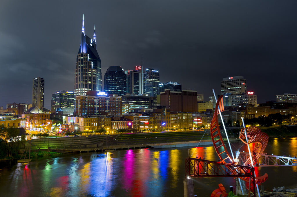Nashville skyline with colors on the water
