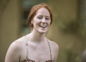 A woman wearing a tank top smiles