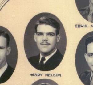 A mustached man in a headshot