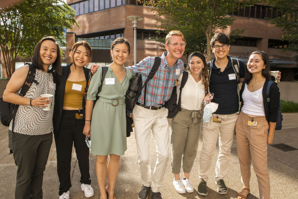 A group of seven medical students pose for a photo outside of the hospital on the first day of orientation