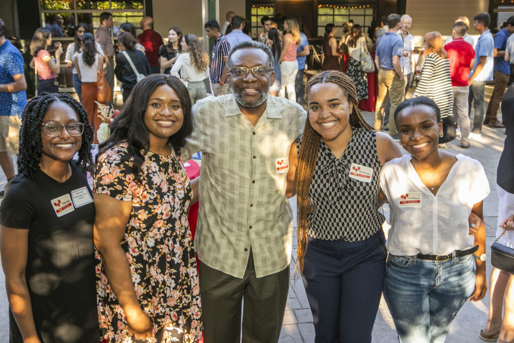 Four Black women and a Black man pose for a photo at a School of Medicine Picnic