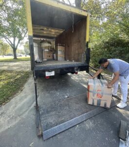 A man packs boxes into a truck