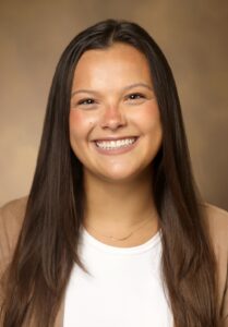 A woman smiles for a professional headshot